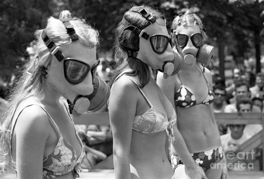 Still image of women in bikinis and gas masks
