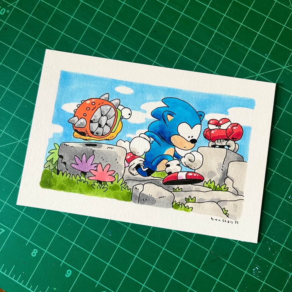 a drawing of sonic the hedgehog running down a stone path, surrounded by crab and snail enemies