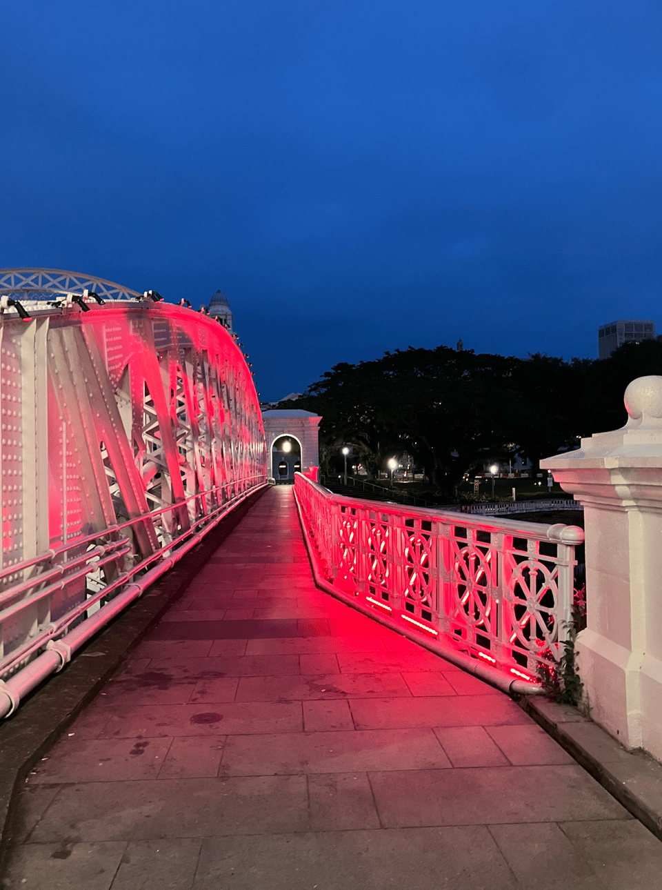 a red-lit walkway over a bridge