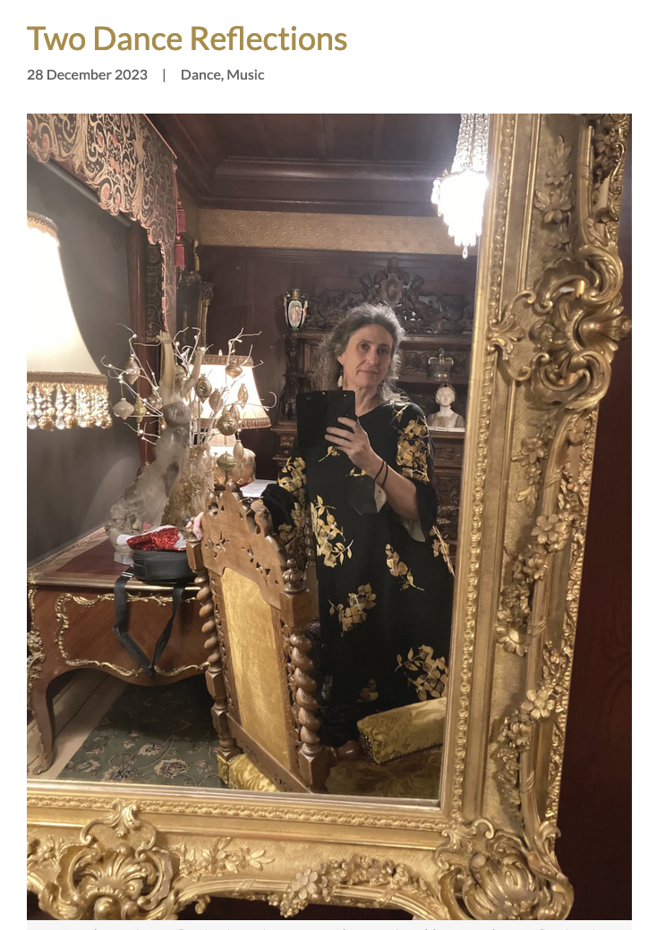 Image alt text: A person in a flower print dress takes a selfie in an ornate gold mirror