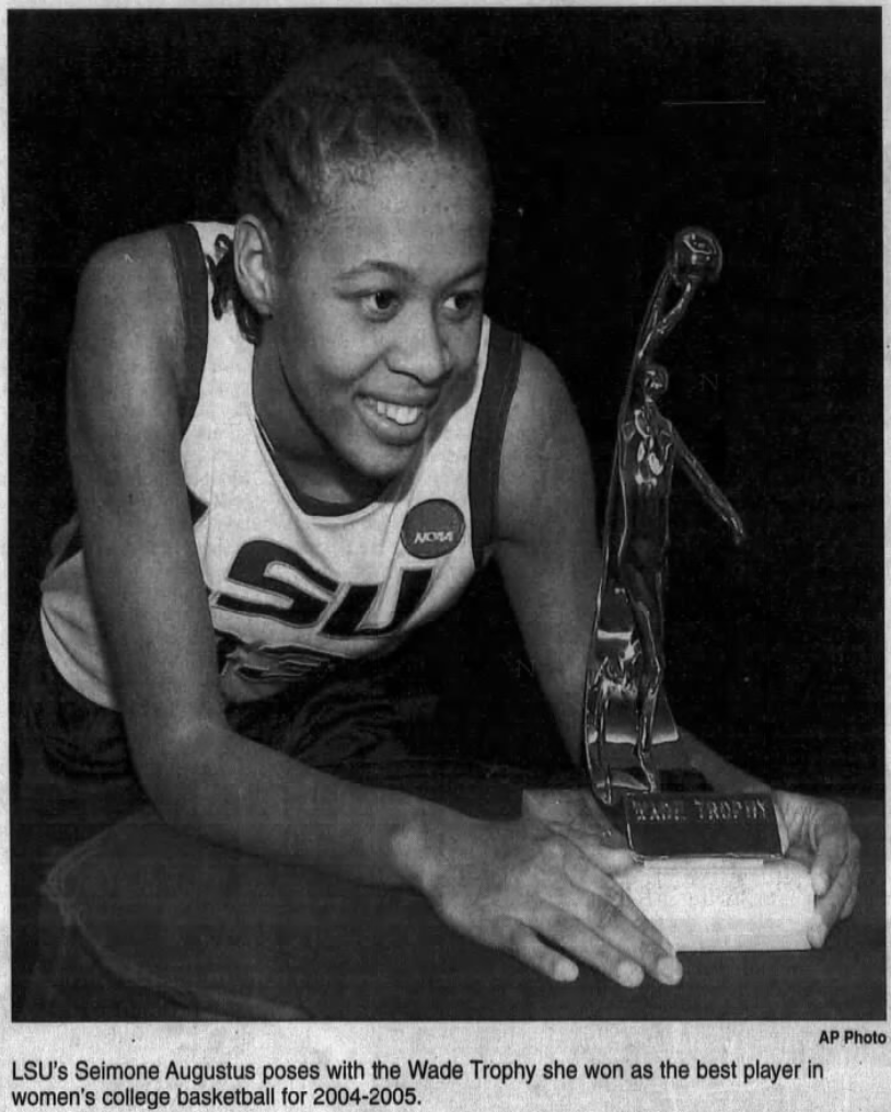 Seimone Augustus in her LSU uniform posing with the Wade Trophy in 2005