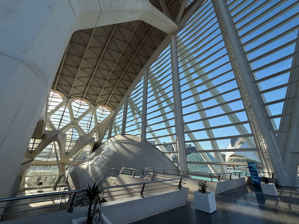 Inside the science museum looking out of the glass windows into the blue sky.
