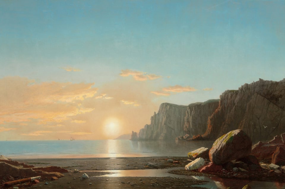 Sunrise over the sea and cliffs.