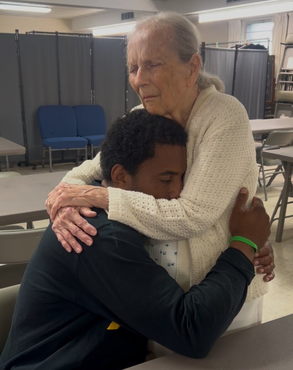 Jesus hugging a homeless friend (through the arms of sister Dolores)