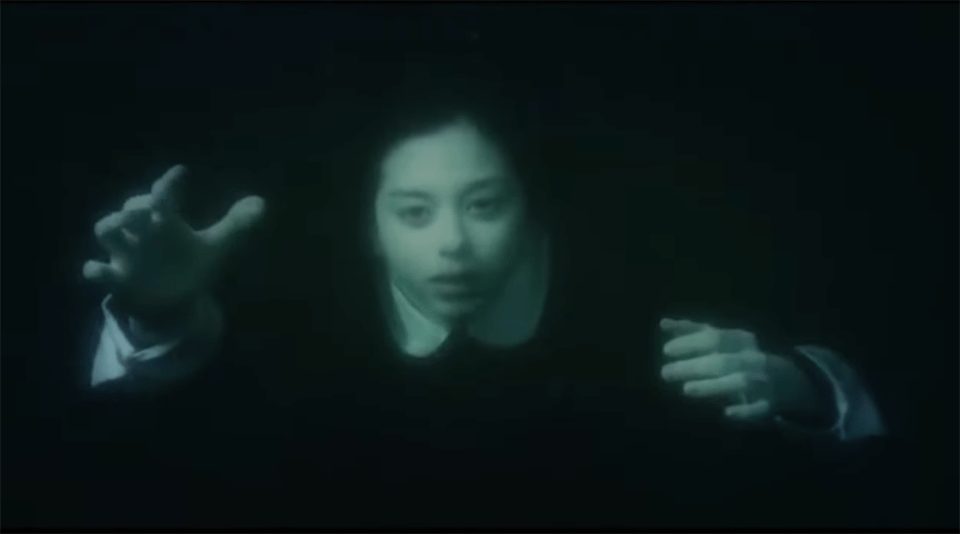A Japanese schoolgirl sinks below the water in Fatal Frame.