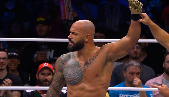 Ricochet's hand is raised after earning a victory in the Continental Classic.