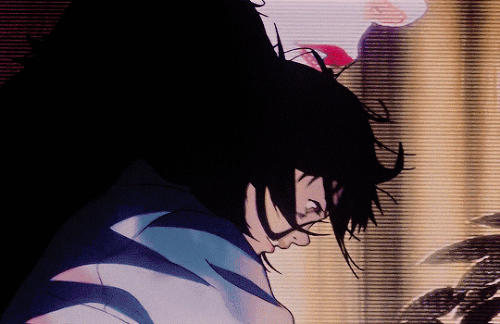 An animated GIF of a character from the anime movie "Perfect Blue" stabbing an indiscernible character against a projected image.