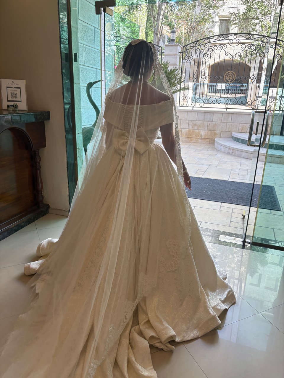 A woman in a wedding dress walking toward outside