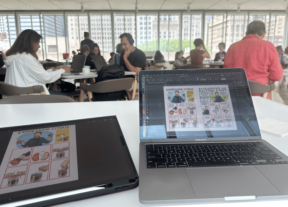 a laptop and tablet in front of a calm room with tables, with a lovely view of downtown Chicago through the windows