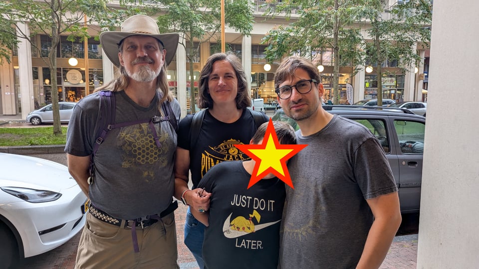 Four people stand together facing the camera.