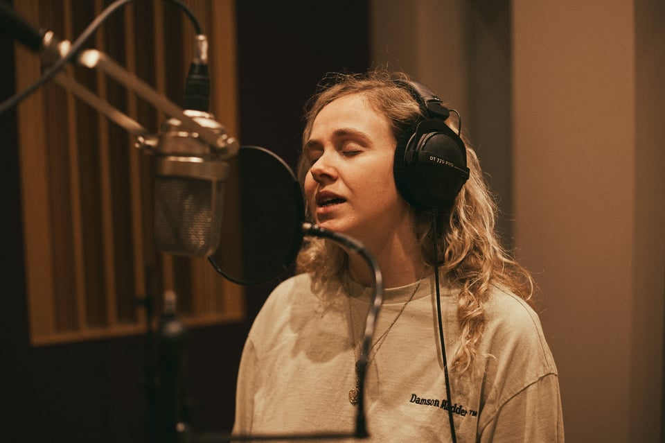 a girl singing into a mic
