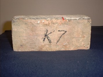 Photograph of a brick that has K7 written on it