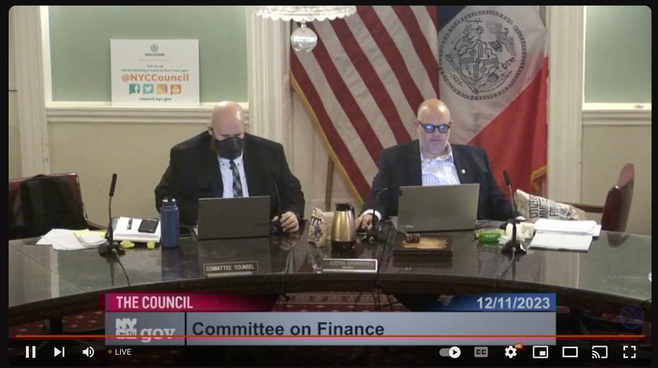 A screenshot of a NYC City Council Hearing featuring Justin Brannan and Committee Counsel.