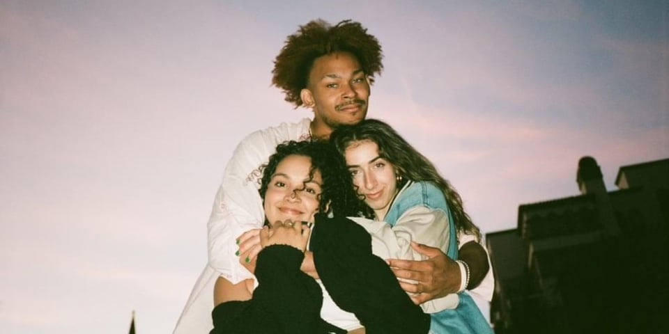 The three members of Tiny Habits have a hug.