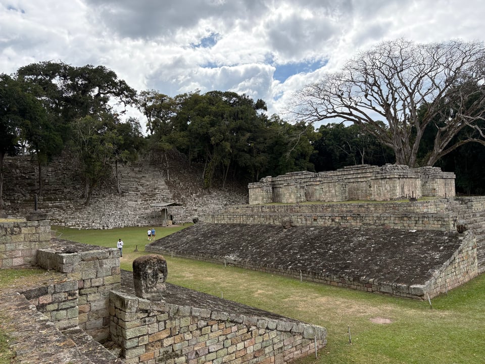 Two sloped ramps lead down to a strip of green grass in the middle, where the ballgame was played