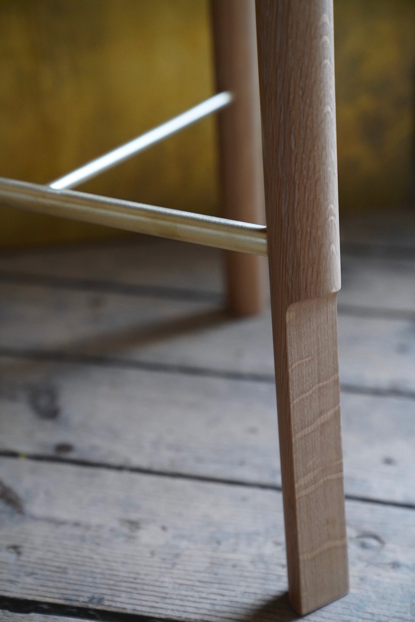 Close up of the brass rungs joining the wooden chair leg