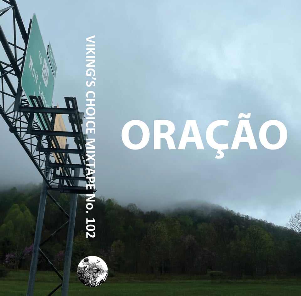 Fog drifting over verdant trees and a highway sign for Wolf Laurel