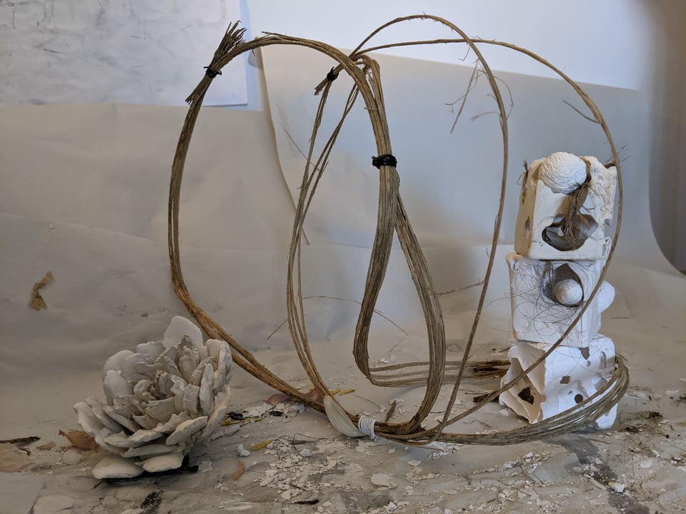 a plaster flower and plaster cubes with looped branches
