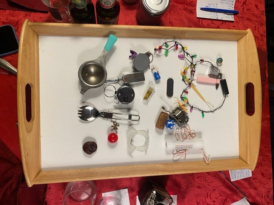 A tray filled with various small household items.
