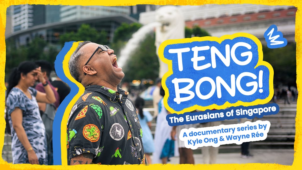 A photo of me, wearing a shirt with TEENAGE MUTANT NINJA TURTLES prints on it. My mouth is open and it looks like I'm trying to drink the water that's gushing out of the Merlion's mouth in the background. Behind me are people walking by. On the right of the photo is the title of the series, TENG BONG! The Eurasians of Singapore. Below the title is the subtitle, "A documentary series by Kyle Ong & Wayne Rée".