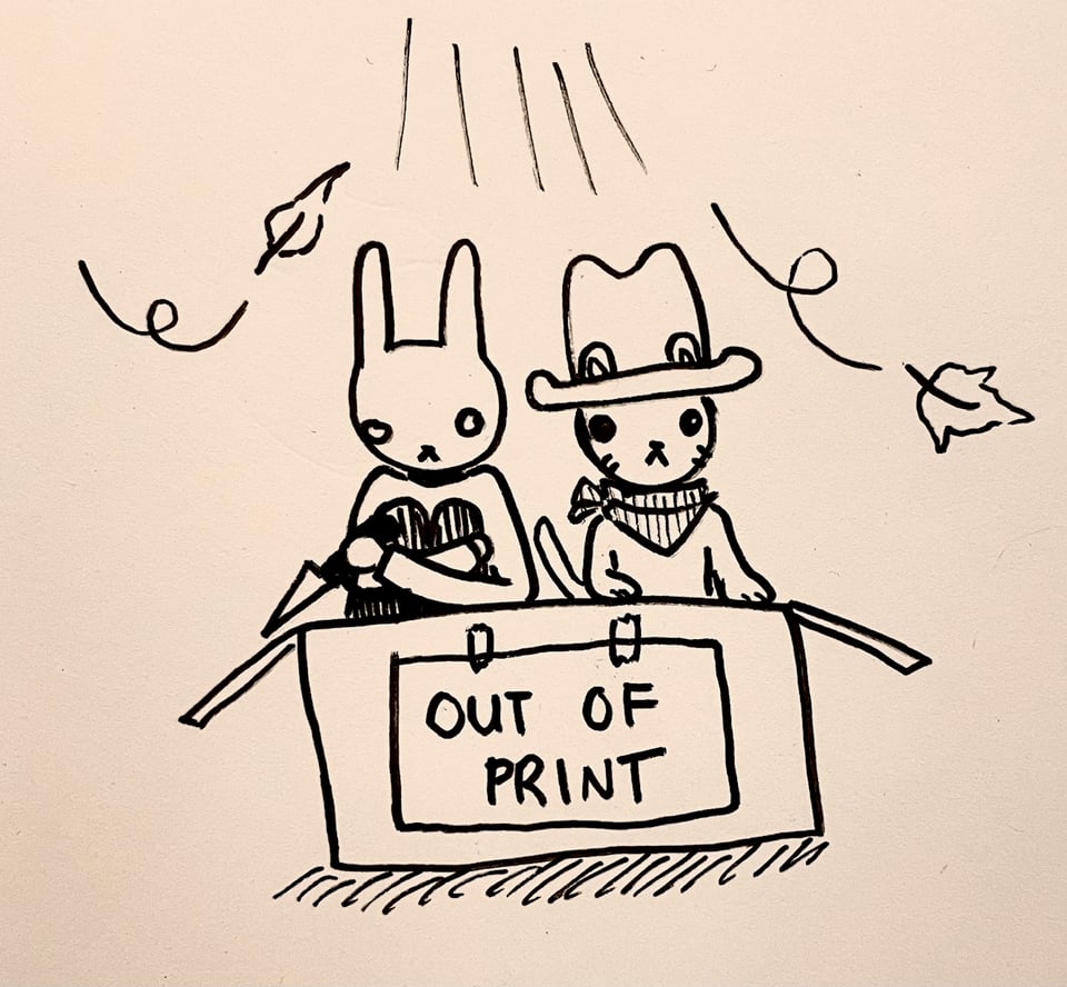 Slasher Bunny and Cowboy Kitty sitting in a cardboard box under a streetlight on a windy night. there is a sign taped to the box that says "out of print."