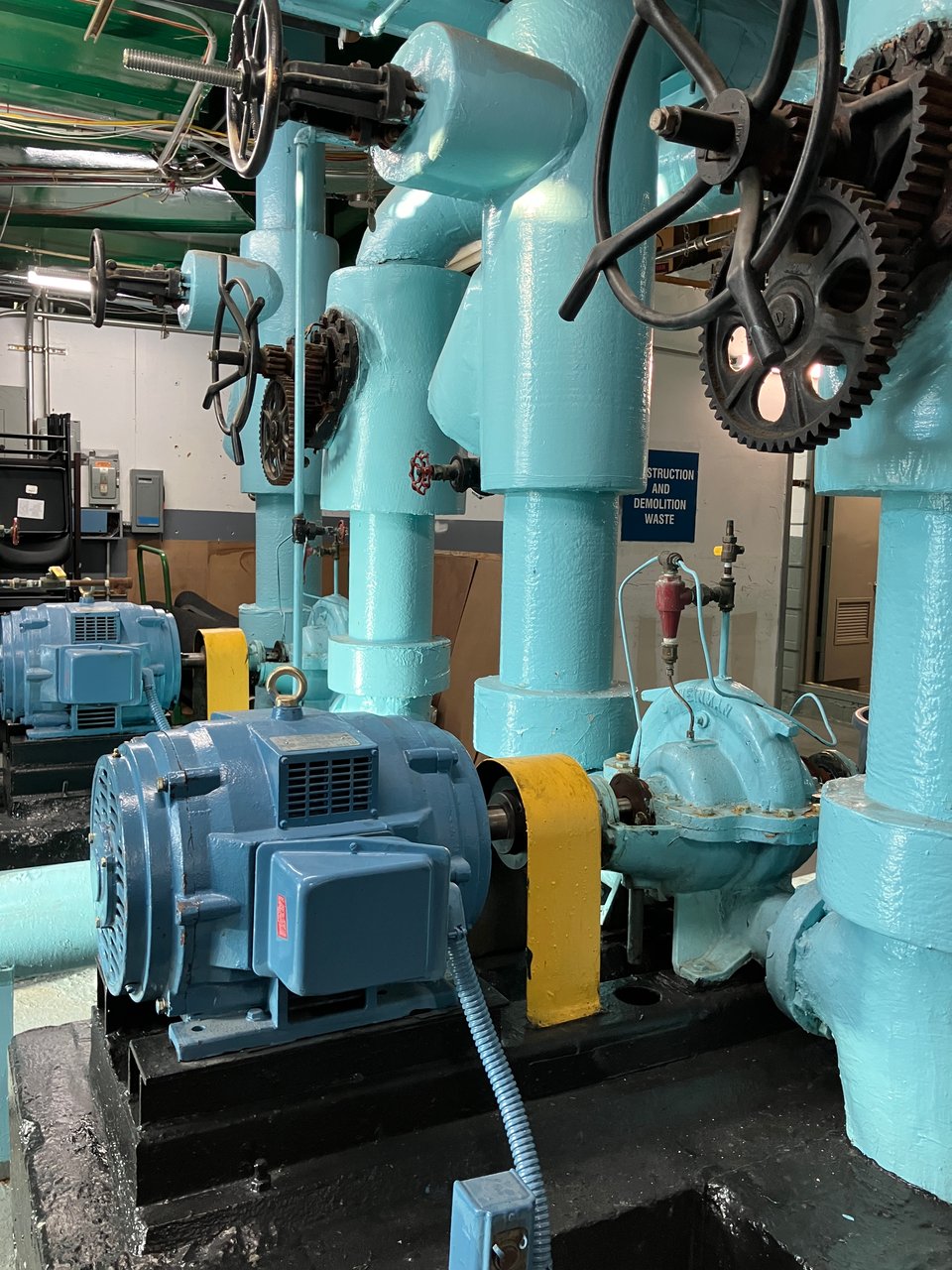 heavy oil based painted teal green and yellow on pipes and mechanical fittings