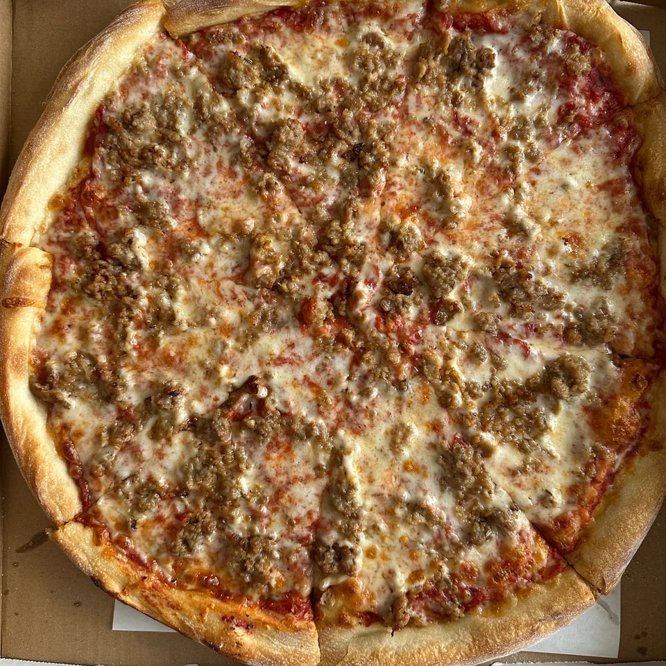 photo of a pizza pie with sausage