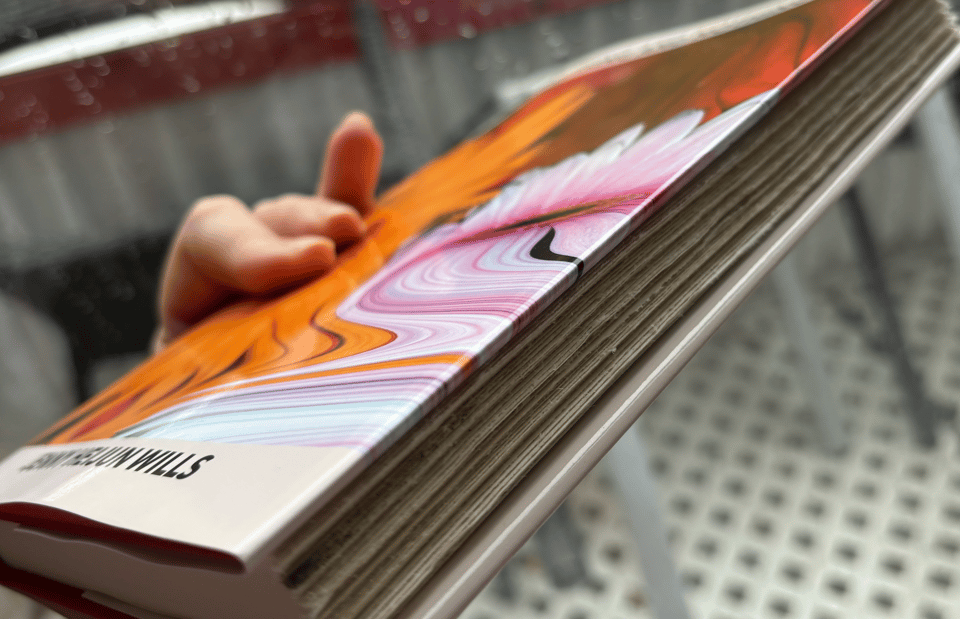 A hardback book held side-on so that you can see the edges of the paper, which are irregular and rough