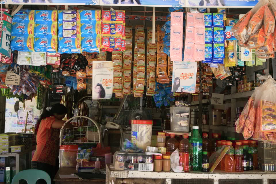 A woman working in a neighborhood market called a Sari-Sari store