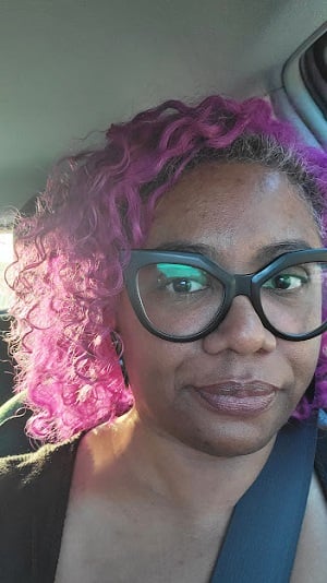 Selfie of Patricia in a car passenger seat during sunset