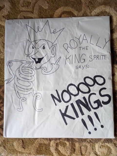 My protest sign, which features a cartoon sprite made of springs. The Text reads: Royally the King Sprite says: NO KINGS!!!