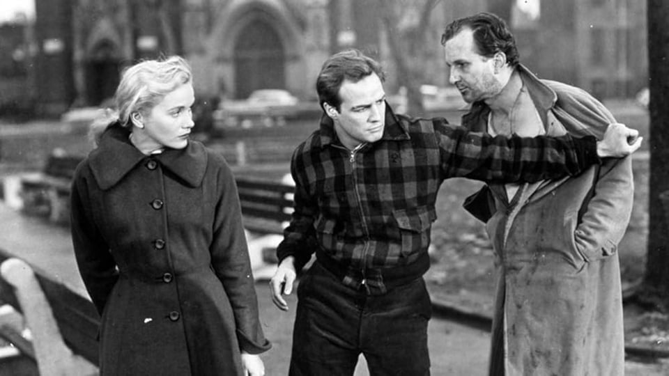 A frame from On the Waterfront (1954). Marlon Brando pushing a guy.