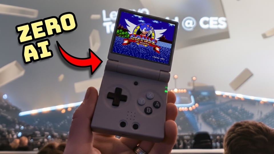 hand holding a small folding retro gaming handheld in stadium seating