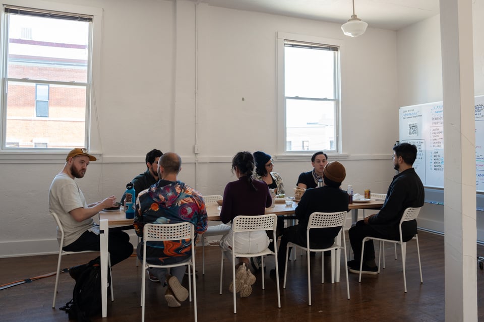 A group of people sitting around a table.