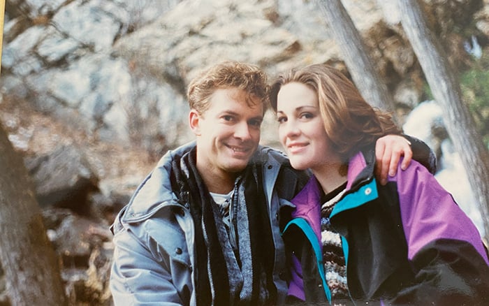 A photo of Matthew and I in 1996, we are in coats, sitting next to each other in a canyon.
