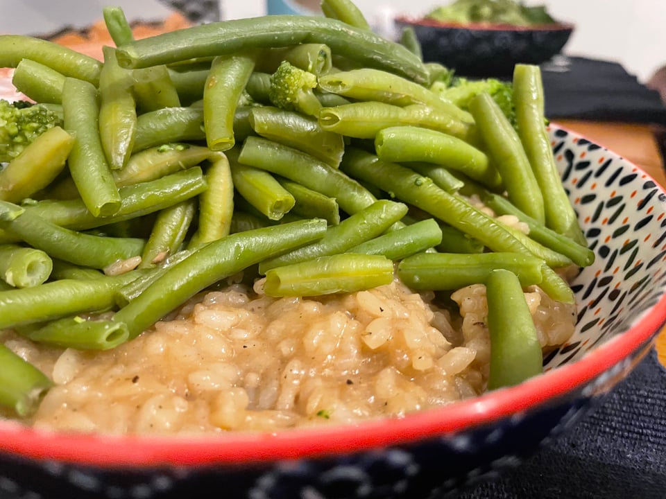 Risotto half covered with green beans