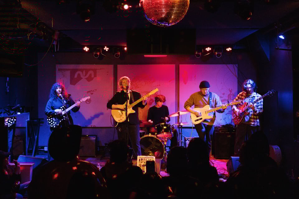 Volena plays at Pianos, you can see all 5 members of the band, and a bit of the disco ball.