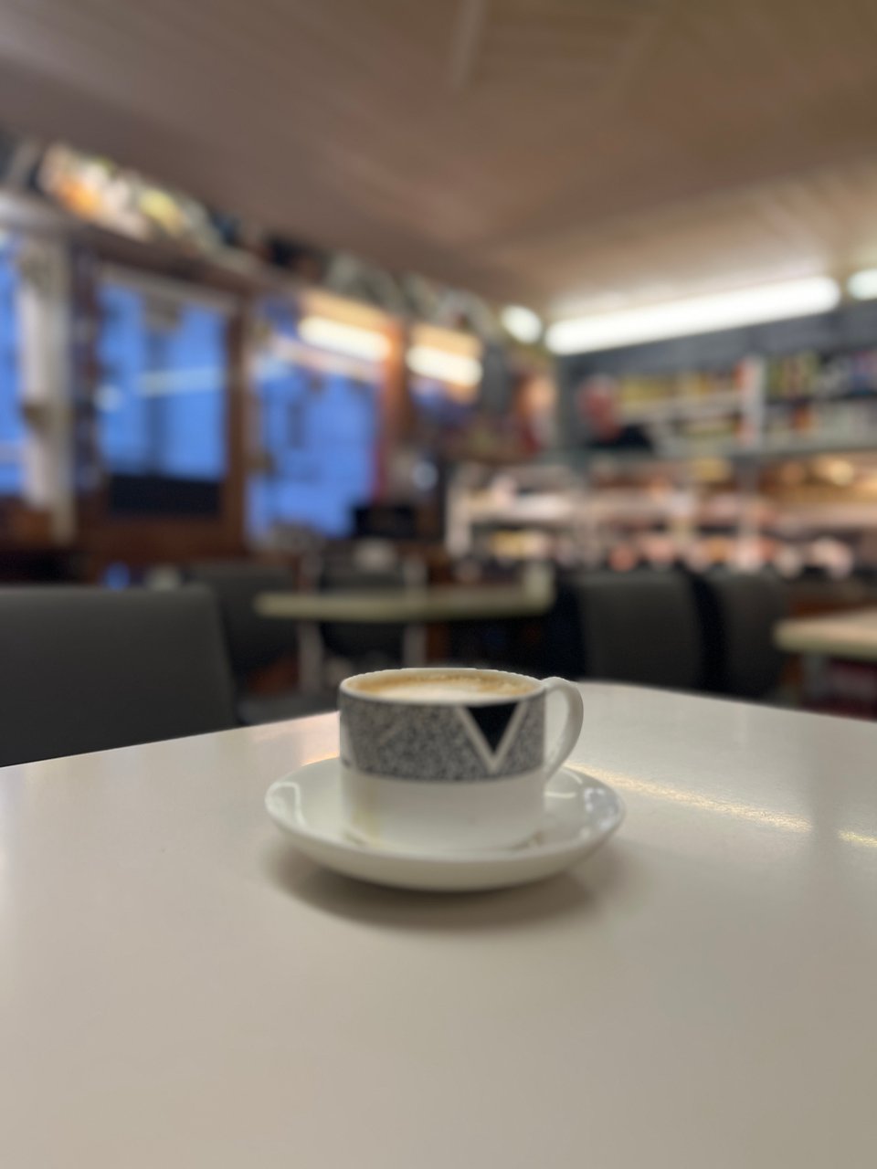 a cup of coffee on a white formica table