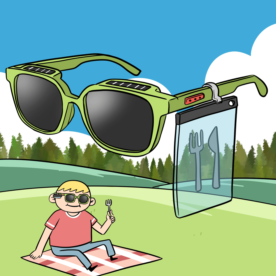 A boy is sitting on a picnic blanket while wearing some sunglasses and holding a fork. Above him some giant sunglasses show off the design which incorporates a window on the side containing a knife and fork and has solar panels on the top.