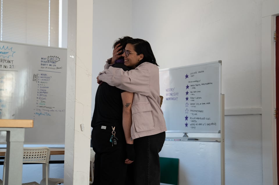 Michelle giving Dan a hug.
