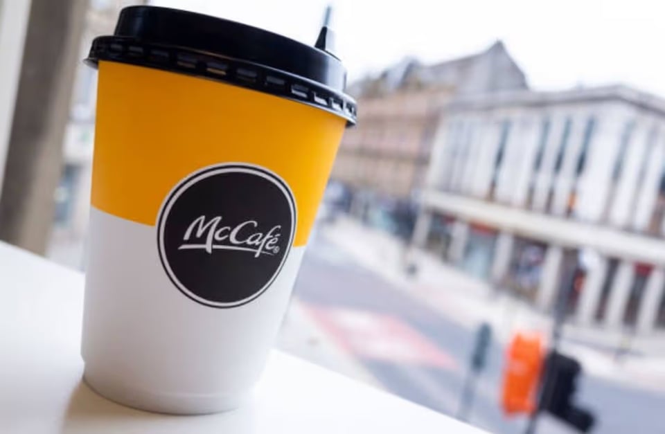 A McCafe coffee in a window.