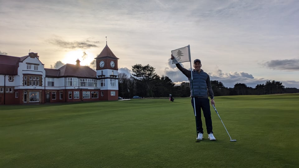 Formby 18th pristine green, clubhouse behind, dipping sun, clock at 2.30pm