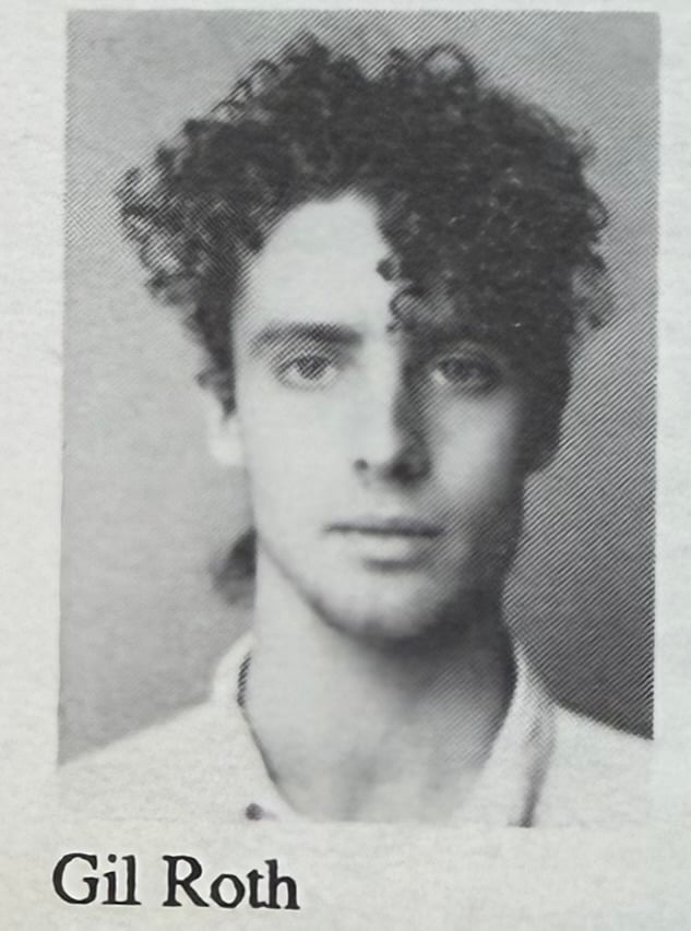 photo of b/w printed image of a white man at 19, with lots of curly hair, and a sorta blank expression on his face. Beneath the picture is the name "Gil Roth"