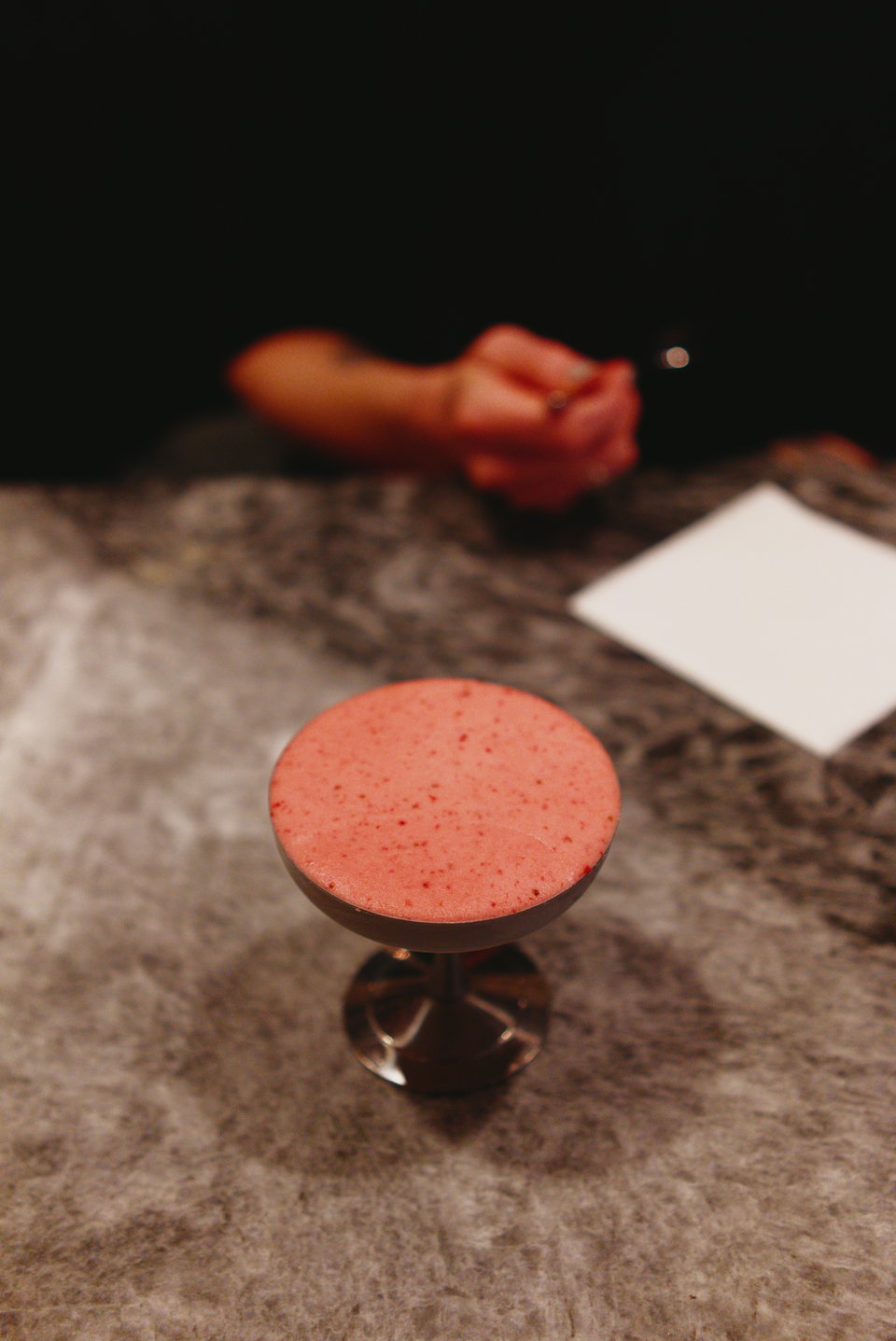 The sobetto sits in a metal cup, perfectly smooth on the top, speckled with fresh strawberry pieces.