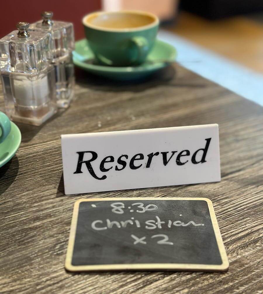 A reserved sign with Christian x2 8:30 beneath