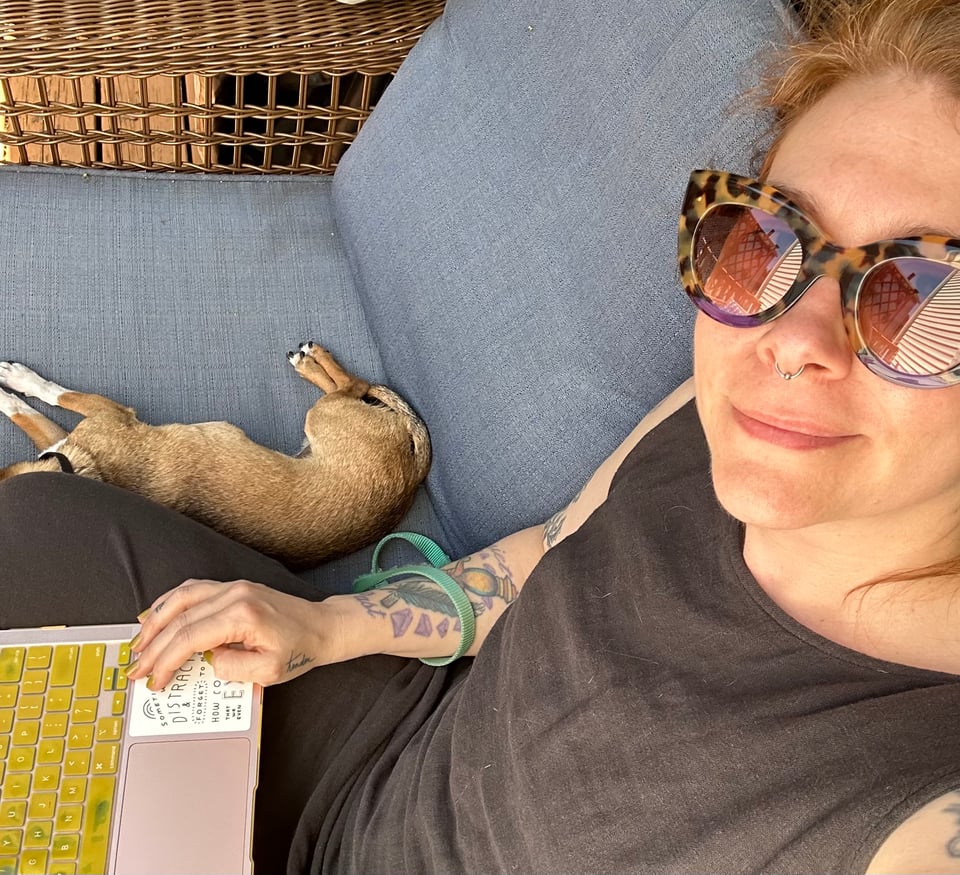 Kate sitting outside with Friday her chihuahua