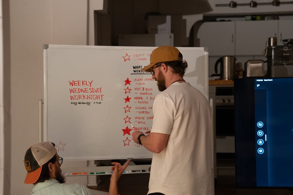 Two people filling out stars on a board.