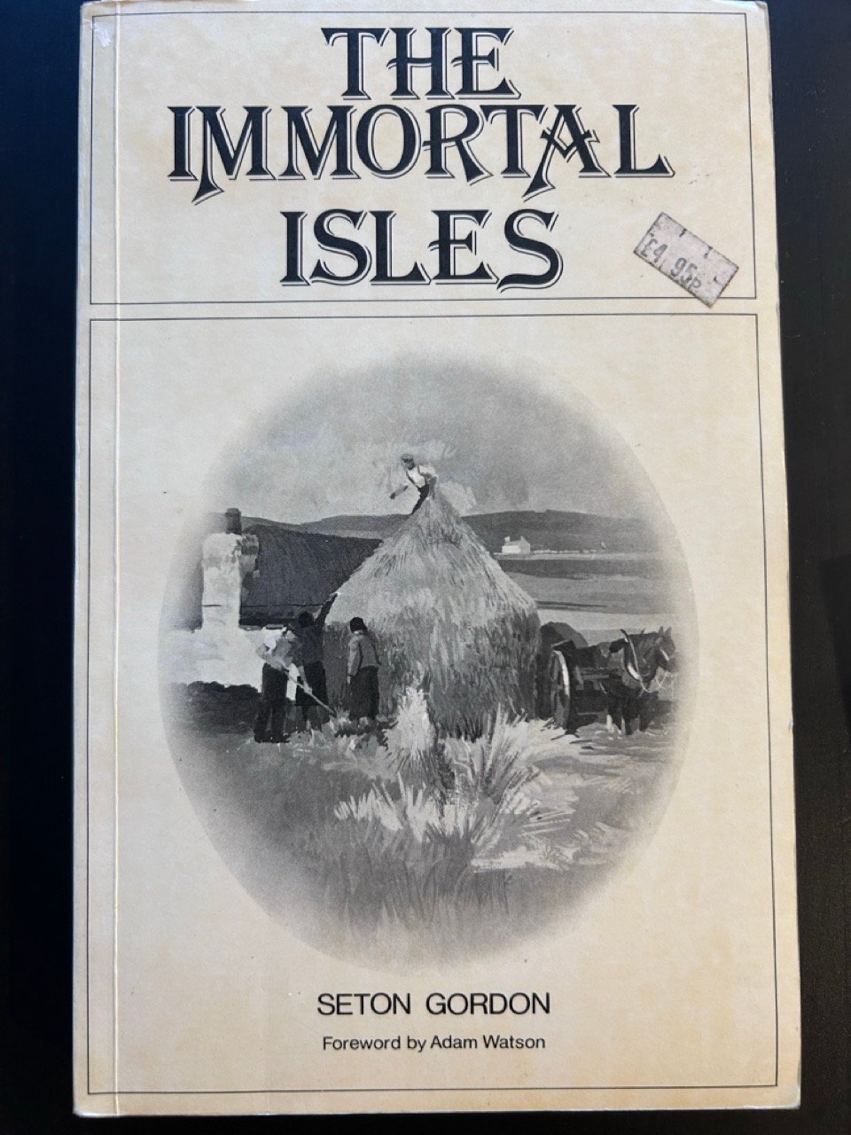 A old, white book with a black and white picture of crofters in the Western Isles