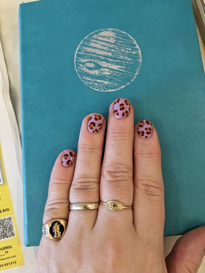 A manicure with leopard print on lavendar.