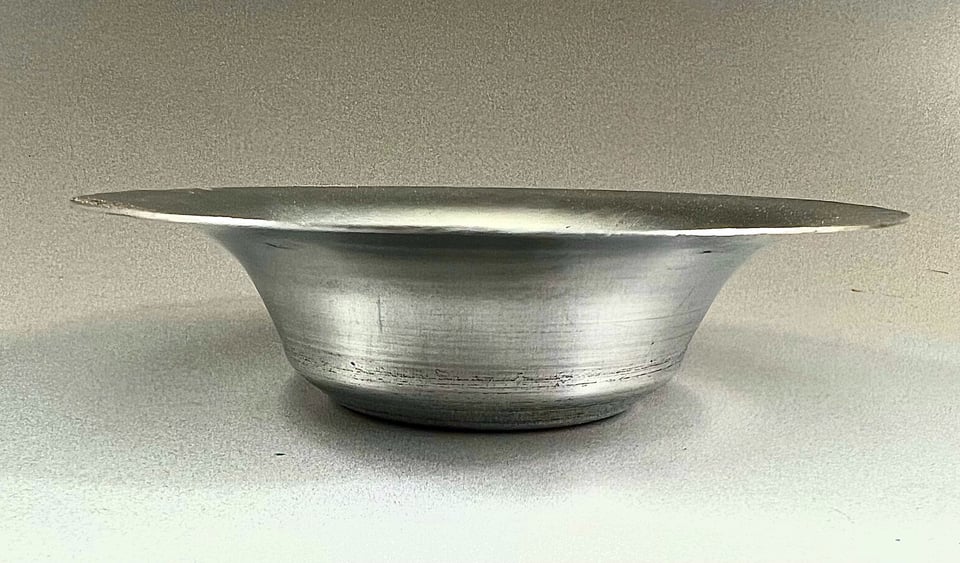 side view of the aluminum bowl with a wide top that tapers down to a narrower bottom